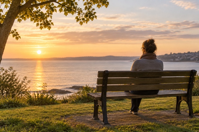 young woman on bench looking a tranquik sea